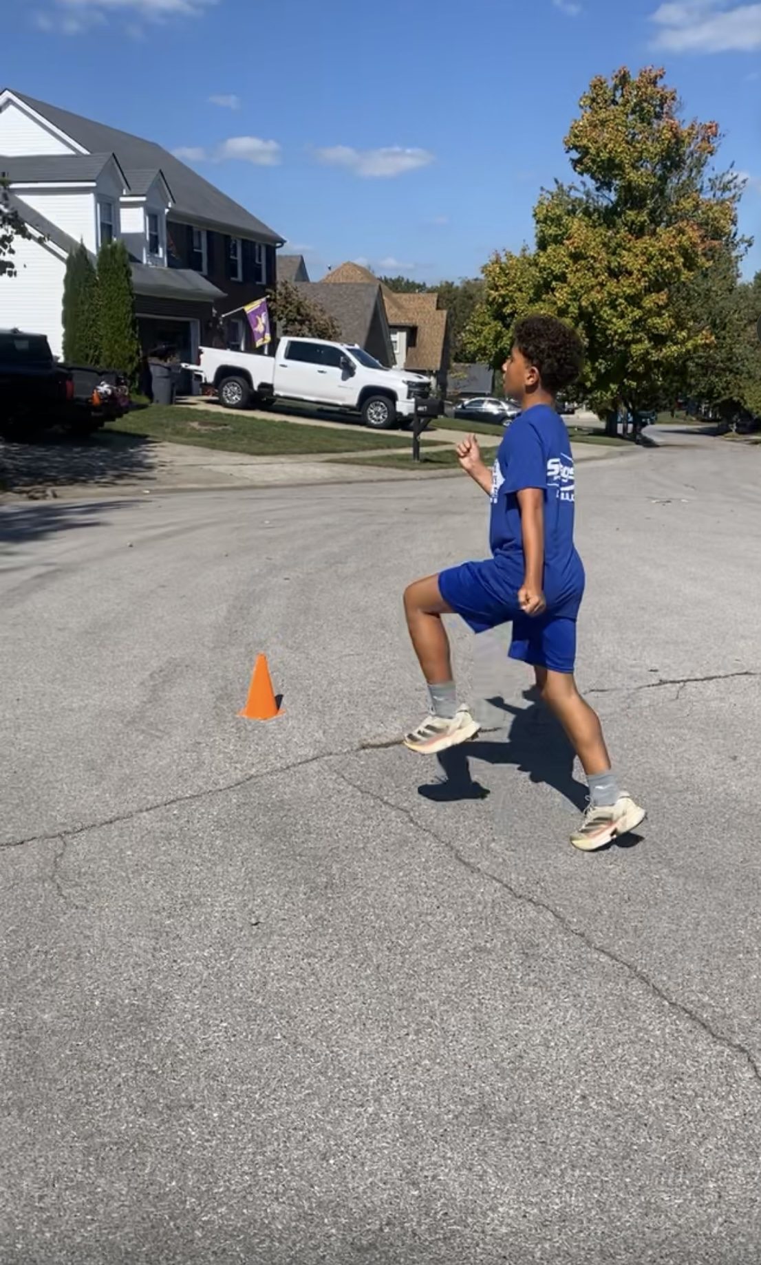 Youth athlete running cone drill outdoors